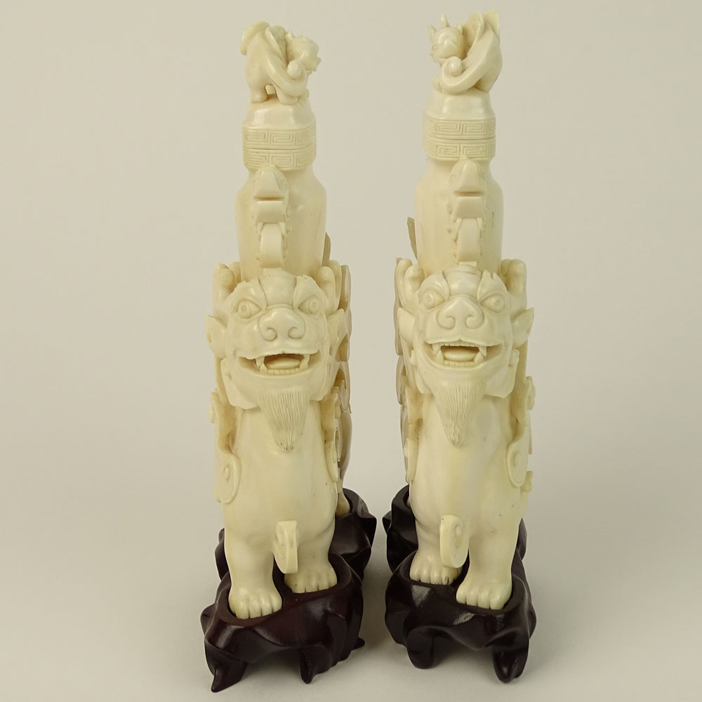 Pair of Vintage well carved Ivory Foo Lion Urns on Hardwood Stands.