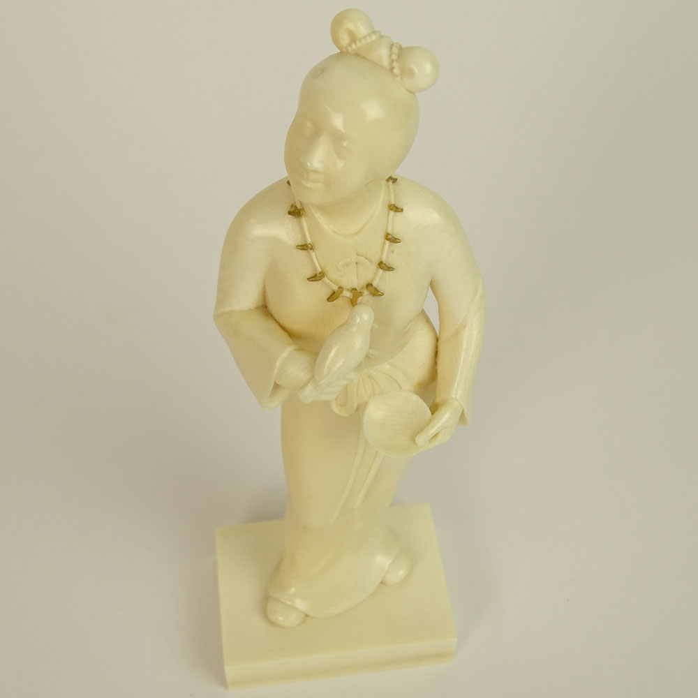 Japanese Finely Carved Ivory Figure of a Female Holding a Bird and Dish.