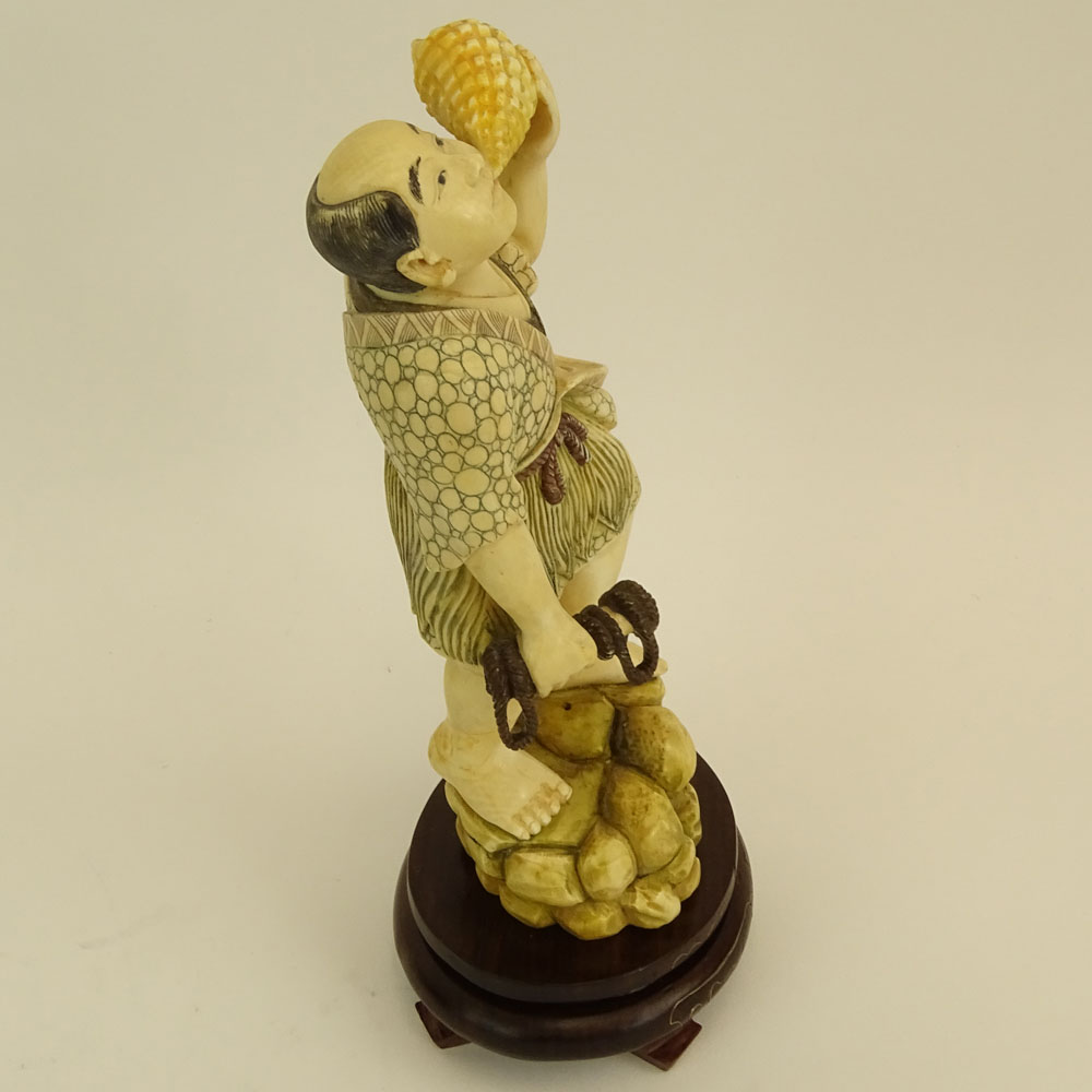 Mid 20th Century Japanese Carved Ivory with wood base, Man with Sea Shell. 