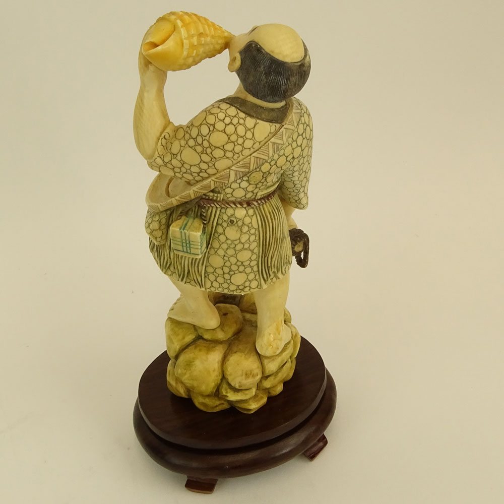 Mid 20th Century Japanese Carved Ivory with wood base, Man with Sea Shell. 