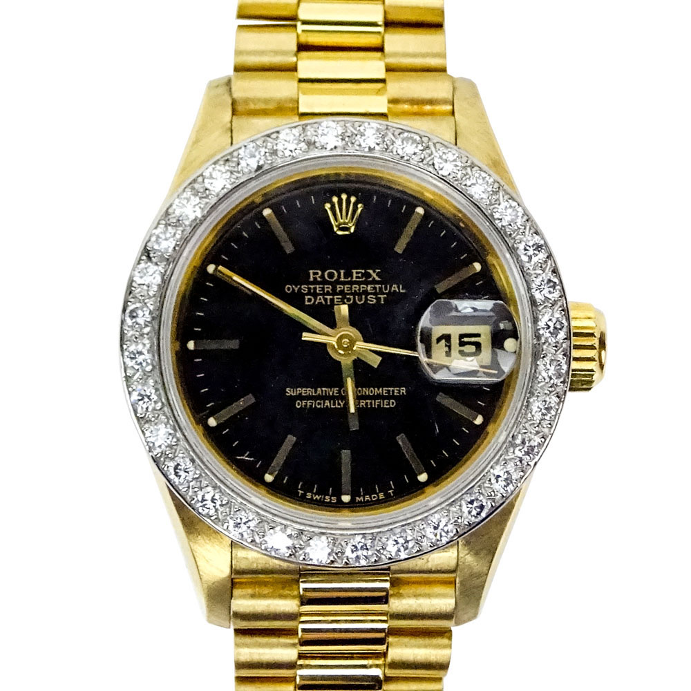 Lady's Vintage Rolex 18 Karat Yellow Gold Datejust Presidential with Diamond Bezel and Black Dial.