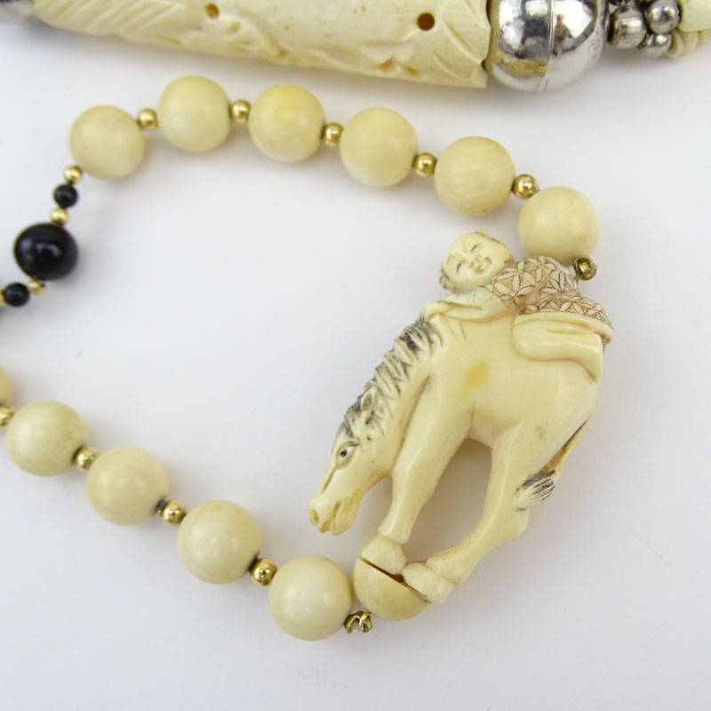 Three Piece Lot Including Carved and Black Onyx Bead Necklace, Carved Bone Necklace and Bangle Bracelet