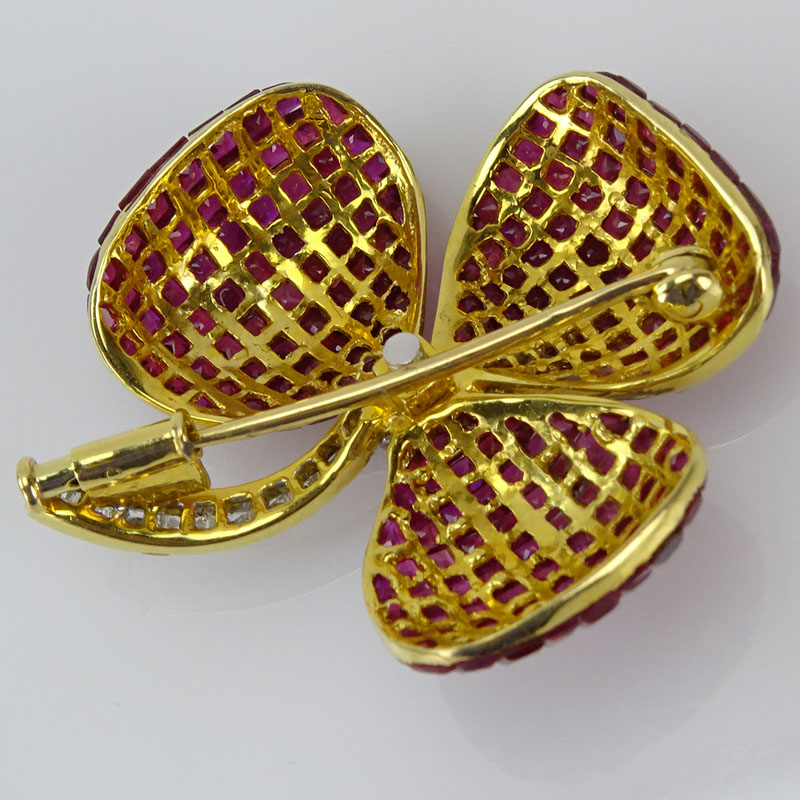  32.50 Carat Invisible Set Square Cut Ruby, .58 Carat Diamond and 18 Karat Yellow Gold Flower Brooch.