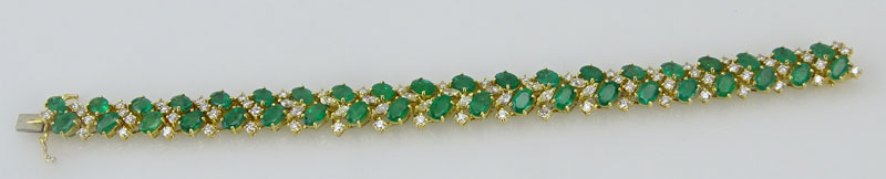 20.0 Carat Oval Cut Emerald, 3.50 Carat Round Brilliant and Marquise Cut Diamond and 18 Karat Yellow Gold Bracelet. Emeralds with vivid saturation of color. Signed 18K. 