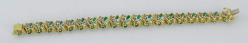 20.0 Carat Oval Cut Emerald, 3.50 Carat Round Brilliant and Marquise Cut Diamond and 18 Karat Yellow Gold Bracelet. Emeralds with vivid saturation of color. Signed 18K. 