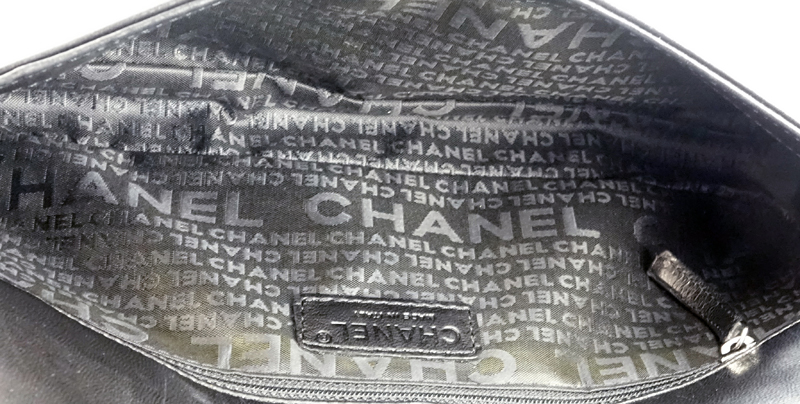 Chanel Black Lambskin Flap Bag. Silver tone hardware, "Chanel" fabric interior with zipper pocket. 