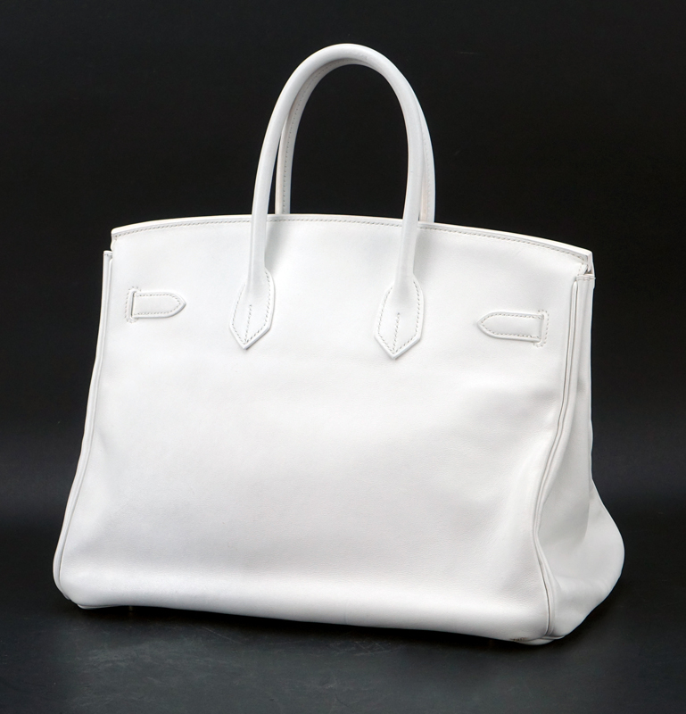 Hermès White Swift Leather Birkin 35 Bag. Palladium hardware. Interior with zipper and slot pocket. Clochette, keys and lock included as well as dust bag. 