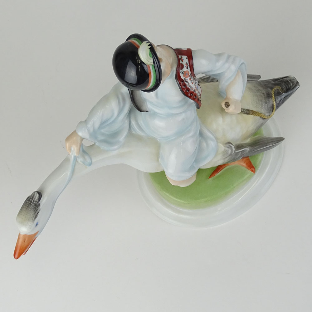 Herend Porcelain Figurine "Boy Riding Goose" Signed with blue Herend backstamp.