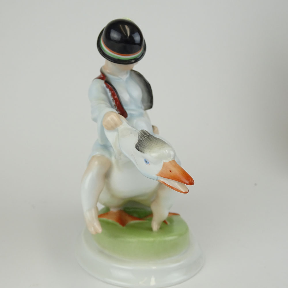 Herend Porcelain Figurine "Boy Riding Goose" Signed with blue Herend backstamp.