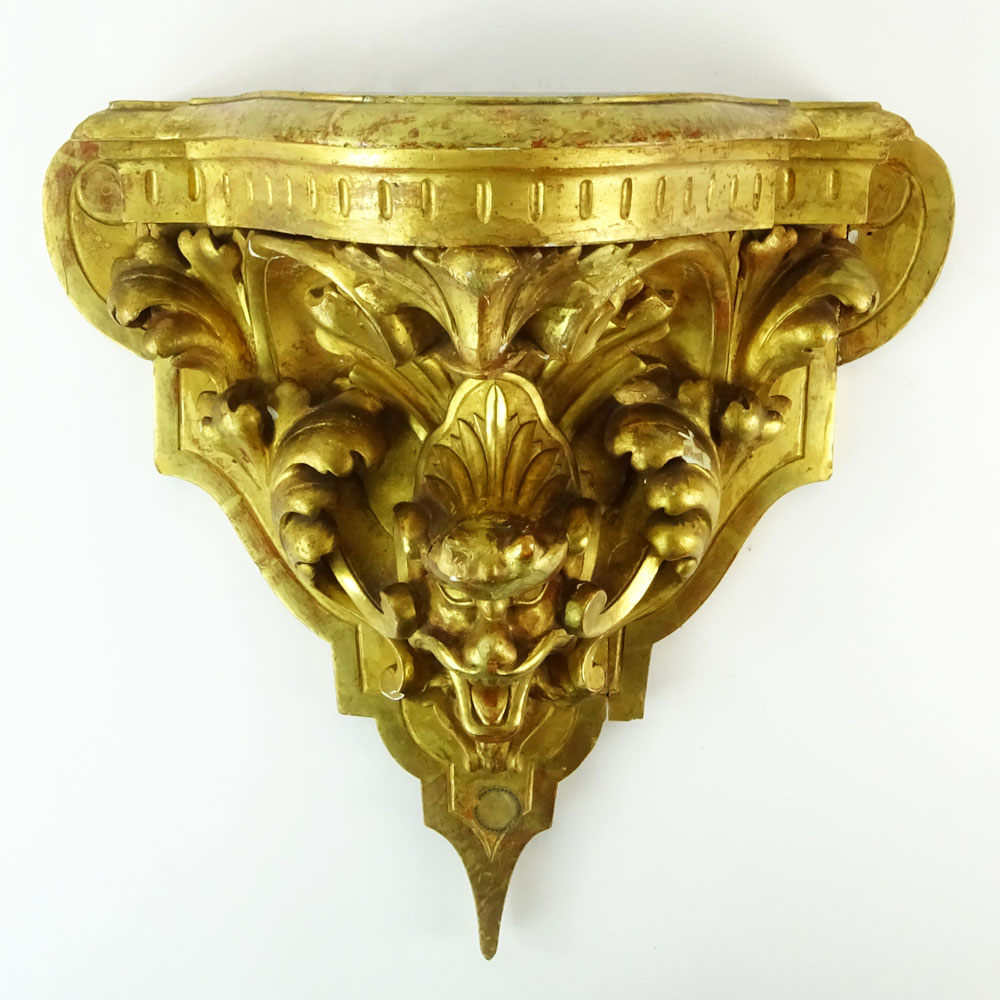 19/20th Century Carved and Gilt Wood Wall Bracket with Relief Mask and Acanthus Leaf Decoration.