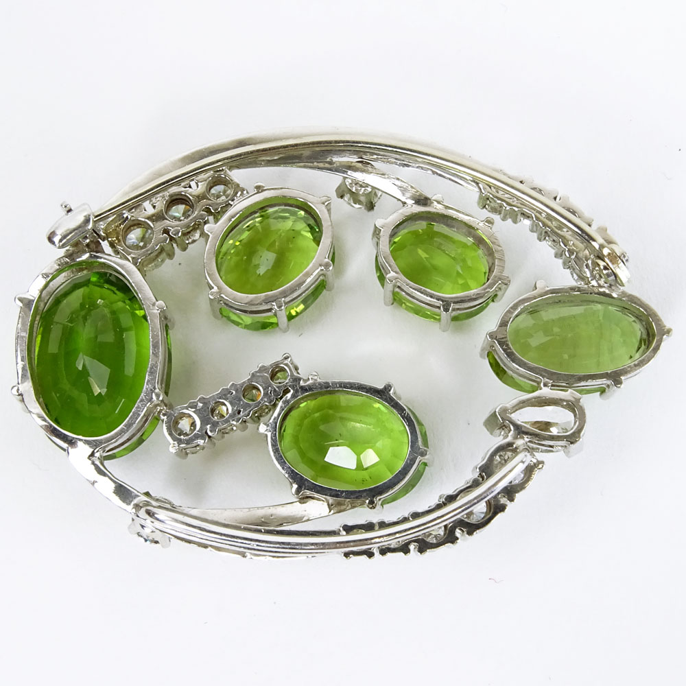 Vintage 2.0-2.25 Carat Diamond, Peridot and 14 Karat White Gold Brooch.