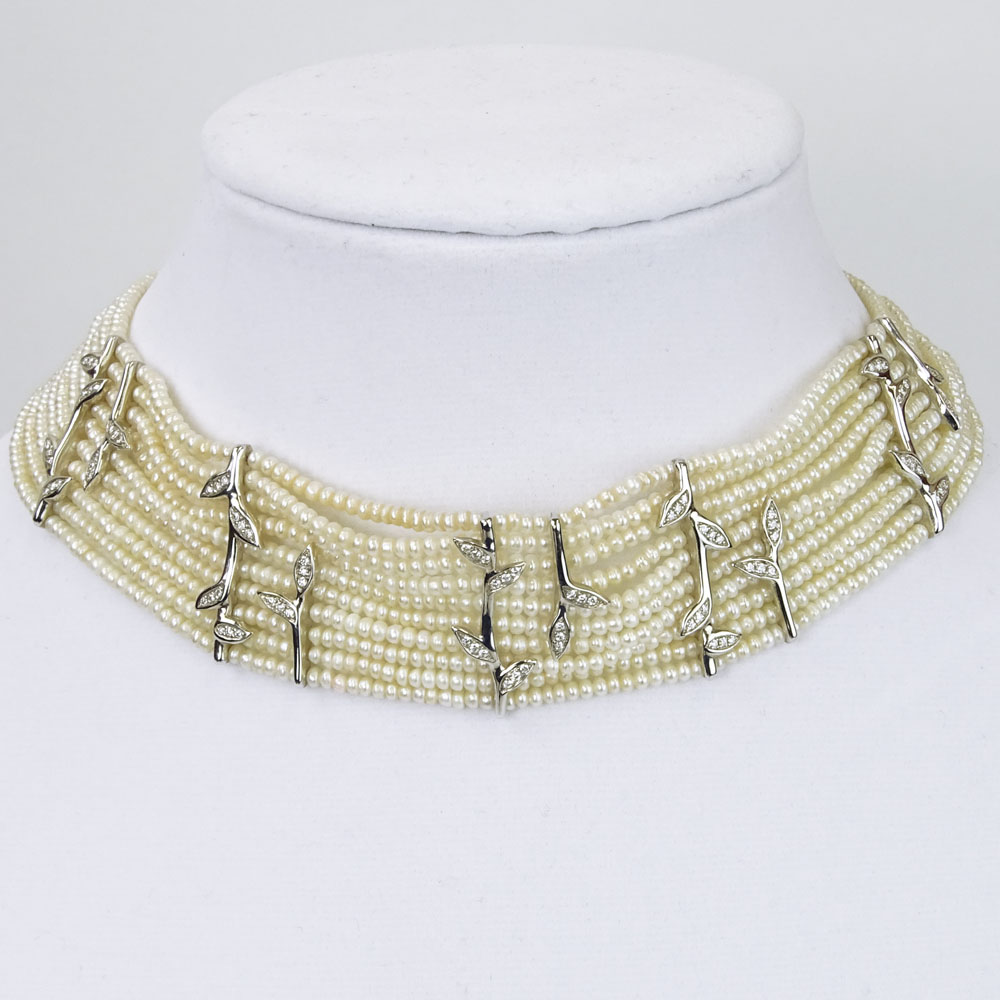 18 Karat White Gold and 10 Strand White Pearl Choker Necklace accented with small round cut diamonds.