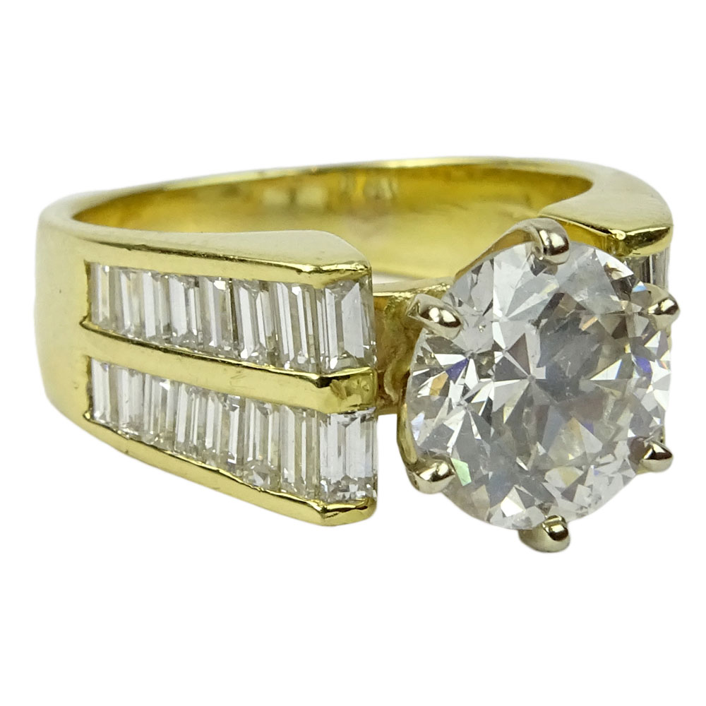 Approx. 2.45 Carat Round Brilliant Cut Diamond and 18 Karat Yellow Gold Engagement Ring Accented with .50 Carat Baguette Cut Diamonds.
