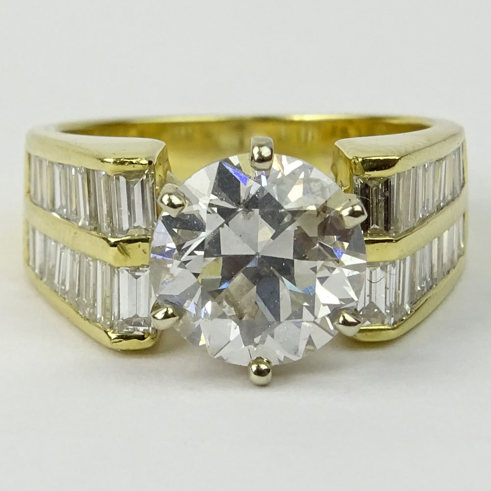 Approx. 2.45 Carat Round Brilliant Cut Diamond and 18 Karat Yellow Gold Engagement Ring Accented with .50 Carat Baguette Cut Diamonds.