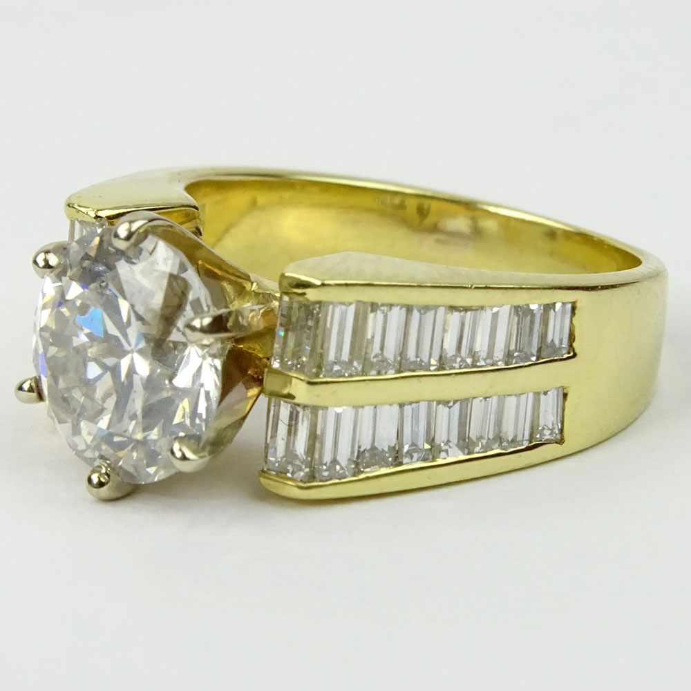 Approx. 2.45 Carat Round Brilliant Cut Diamond and 18 Karat Yellow Gold Engagement Ring Accented with .50 Carat Baguette Cut Diamonds.