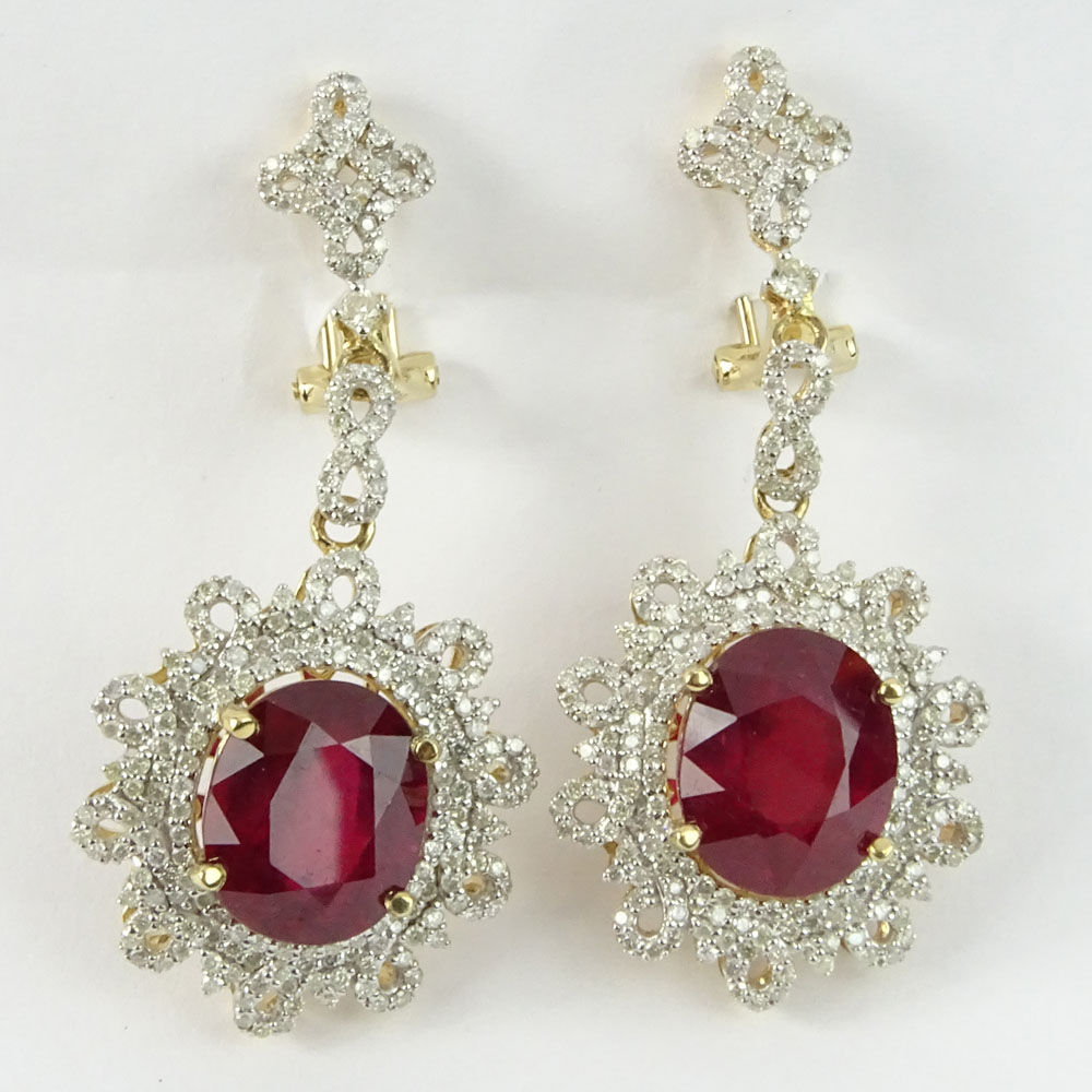 GGA Certified 13.74 Carat Oval Cut Ruby, 1.84 Carat Round Cut Diamond and 14 Karat Yellow Gold Earrings. 