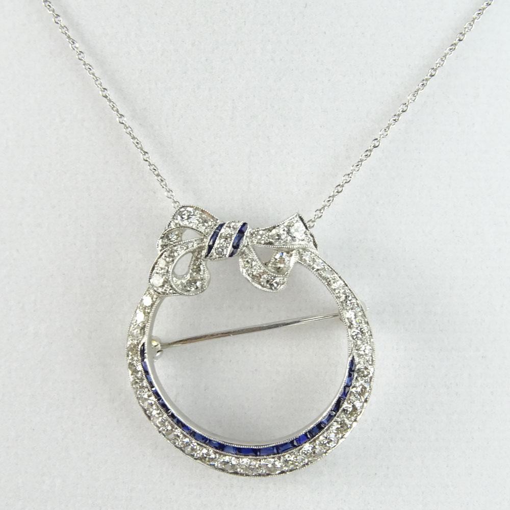 Art Deco Circa 1920's Approx. 2.0 Carat Round Cut Diamond, Sapphire and Platinum Pendant/Brooch with 14 Karat White Gold Chain. 