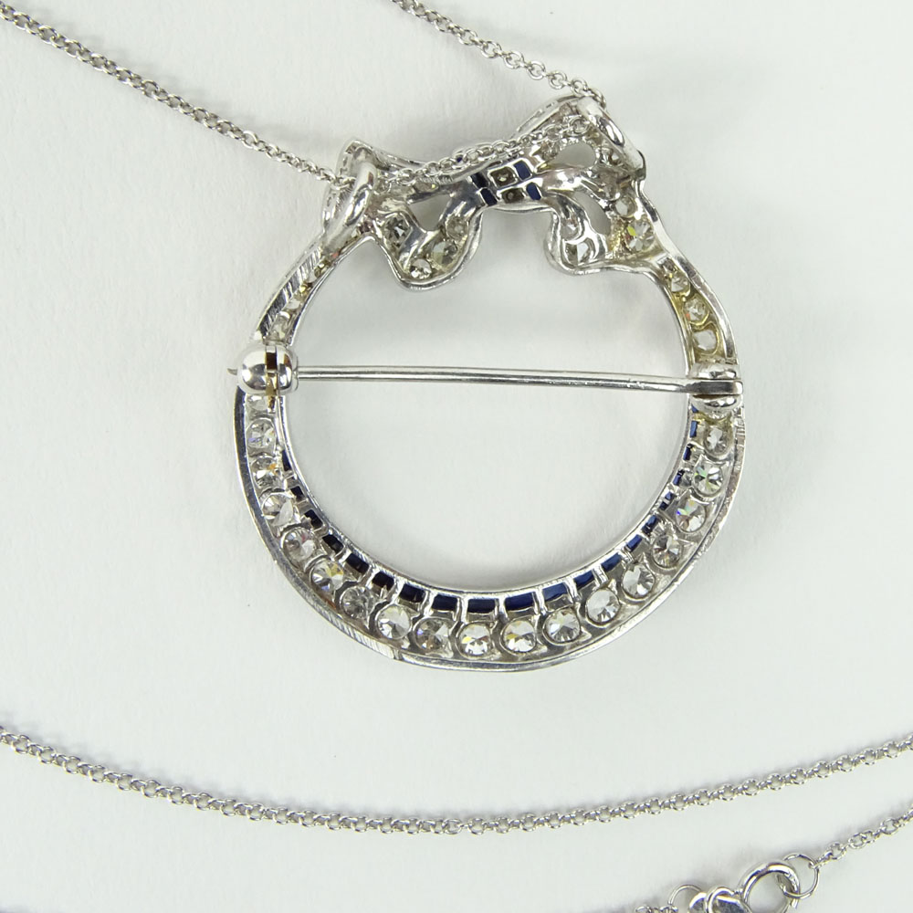 Art Deco Circa 1920's Approx. 2.0 Carat Round Cut Diamond, Sapphire and Platinum Pendant/Brooch with 14 Karat White Gold Chain. 