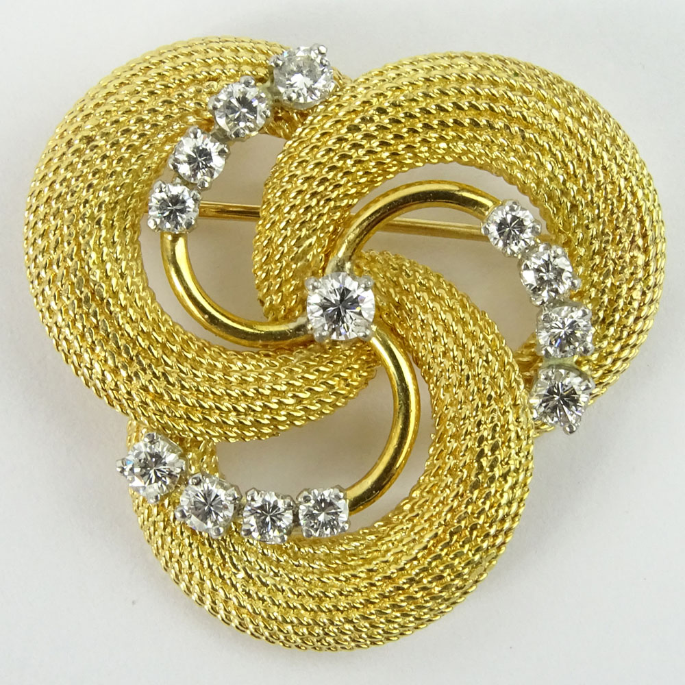 Vintage 18 Karat Yellow Gold and Approx. 1.20 Carat Round Cut Diamond swirl Brooch.