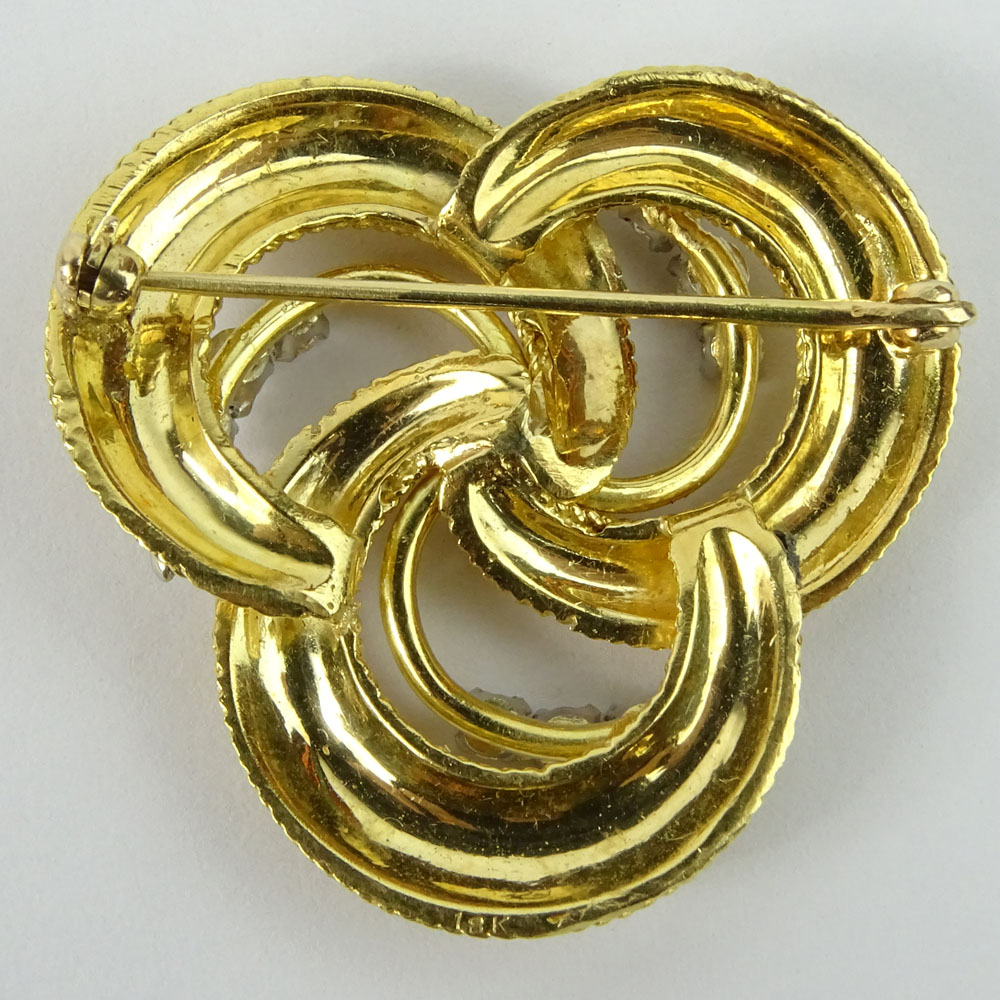 Vintage 18 Karat Yellow Gold and Approx. 1.20 Carat Round Cut Diamond swirl Brooch.