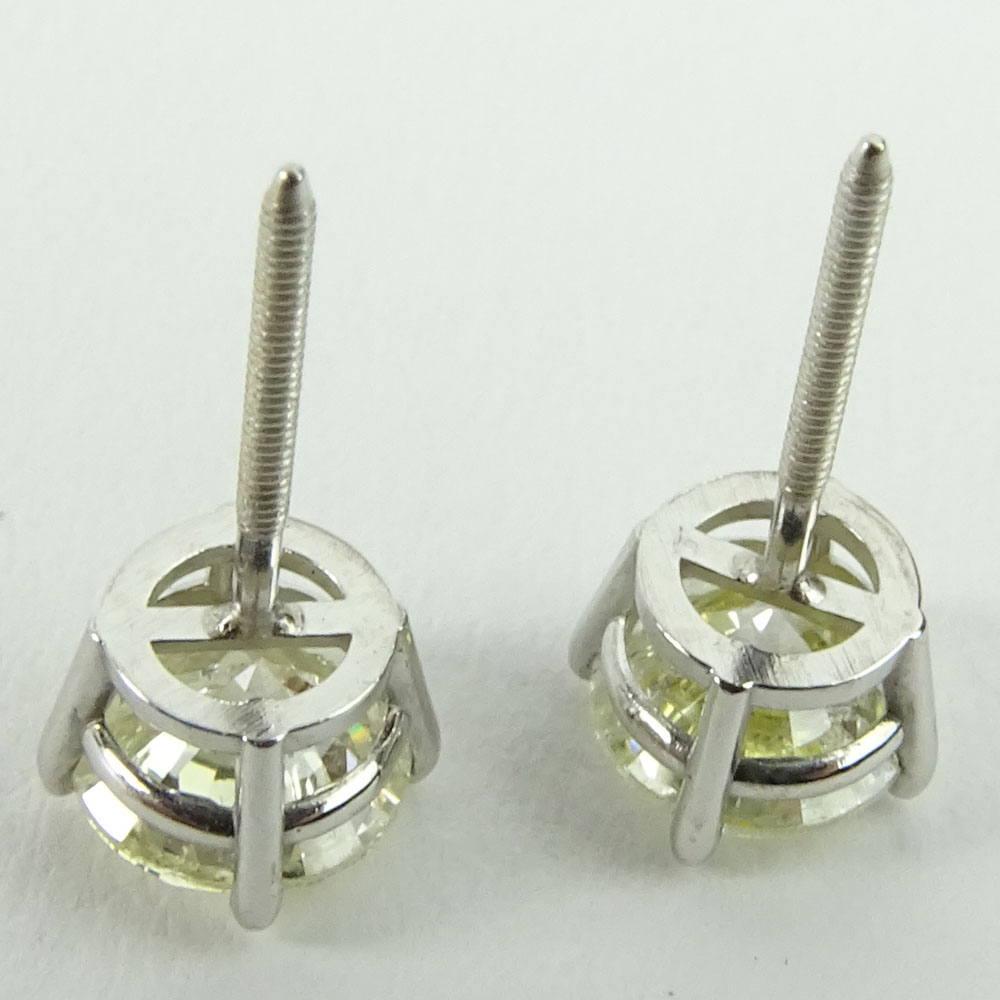 AIG Certified 1.41 Carat Total Weight Round Cut Diamond and 14 Karat White Gold Ear Studs.