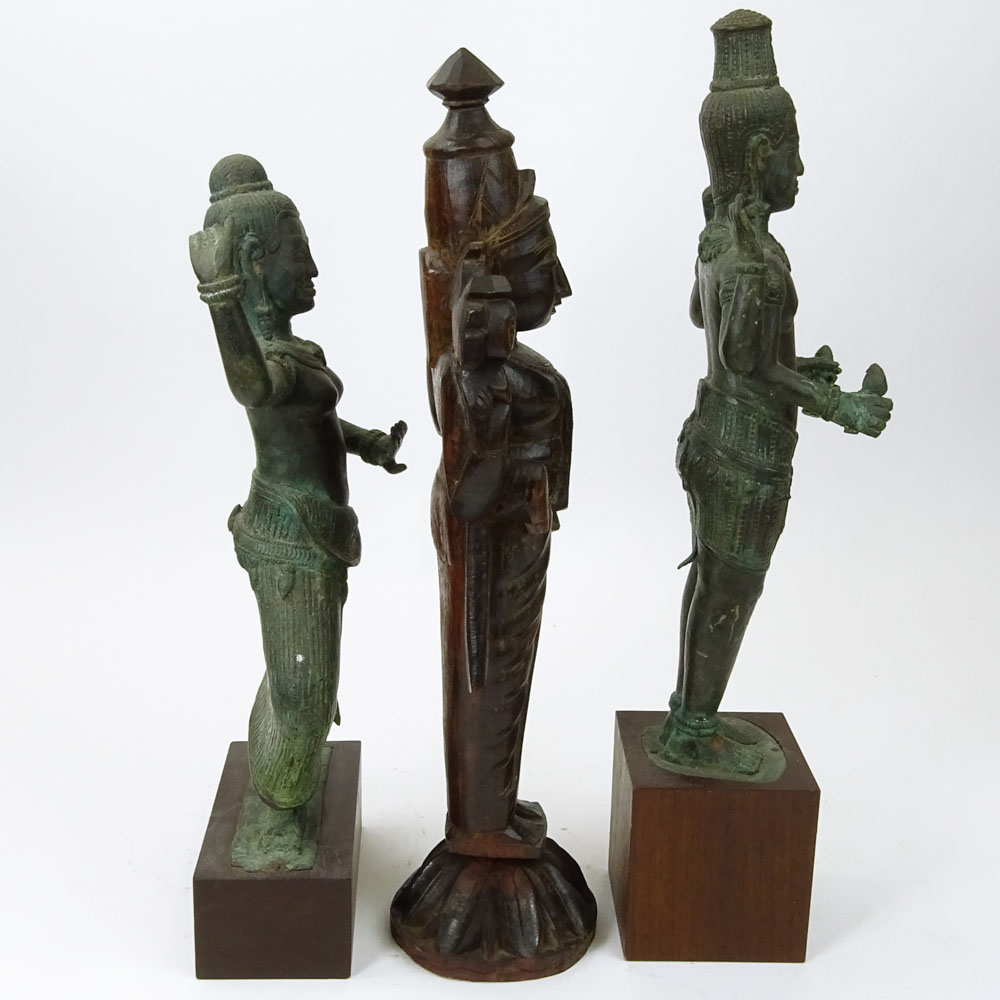 Pair of Modern Tibetan Style Cast Metal Figures on Wood Stands Together with a Carved Wood Figurine.