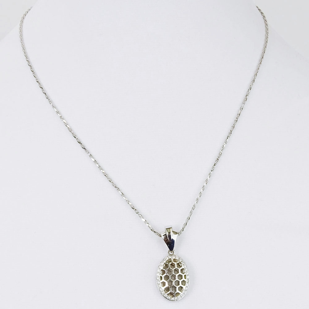 Lady's 18 Karat White Gold Pendant Necklace Accented with Small Round Cut Diamonds.