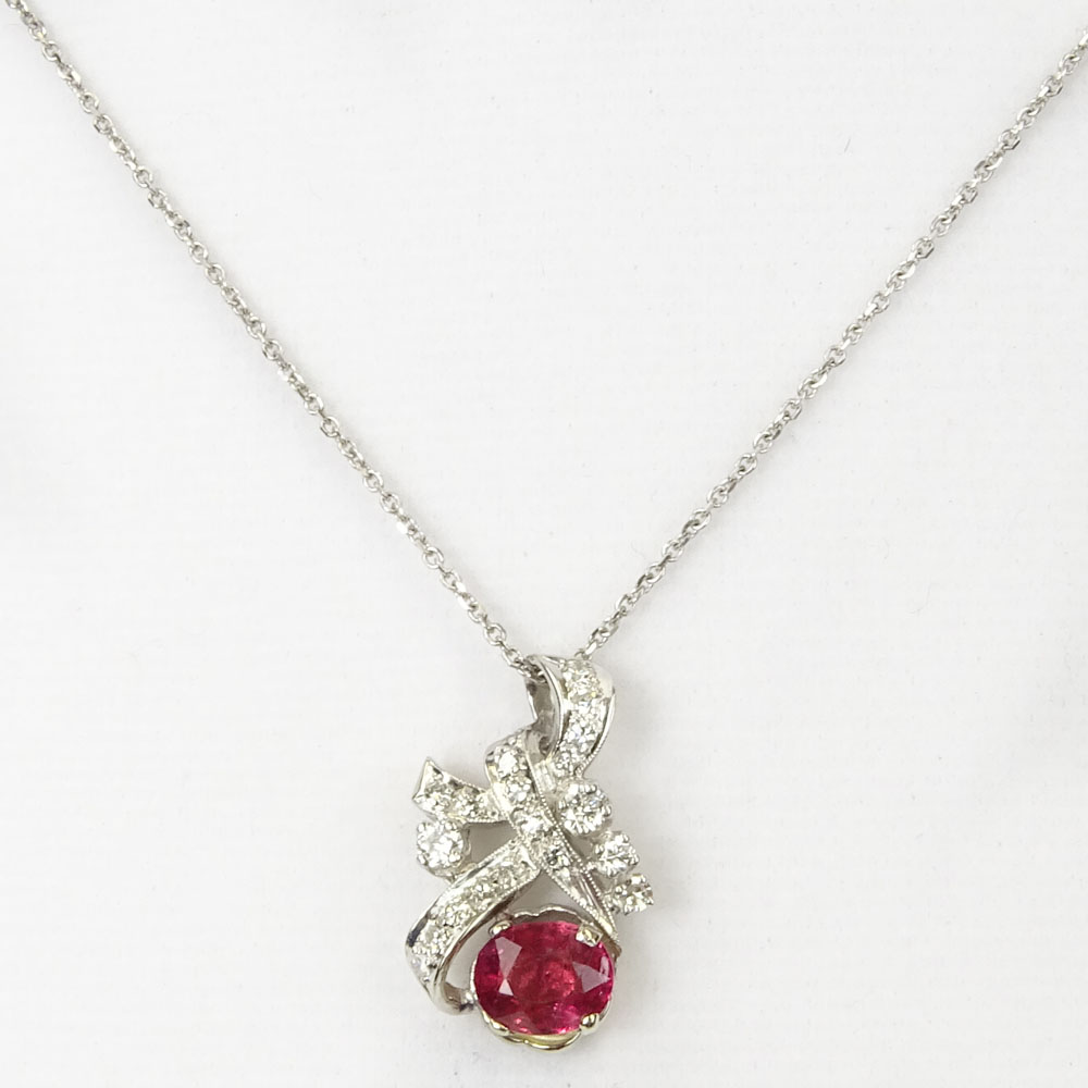 Vintage Oval Cut Ruby, Diamond and 18 Karat White Gold Pendant with 14 Karat White Gold Chain.