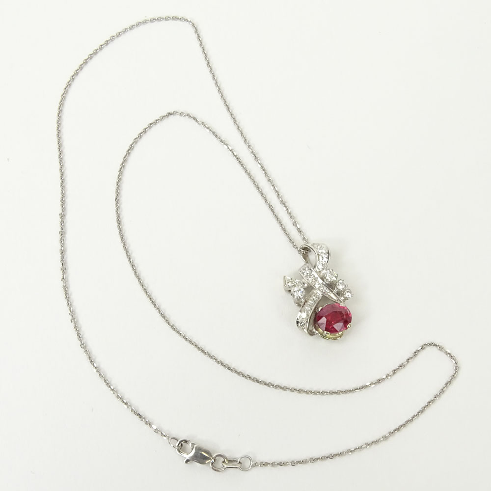 Vintage Oval Cut Ruby, Diamond and 18 Karat White Gold Pendant with 14 Karat White Gold Chain.