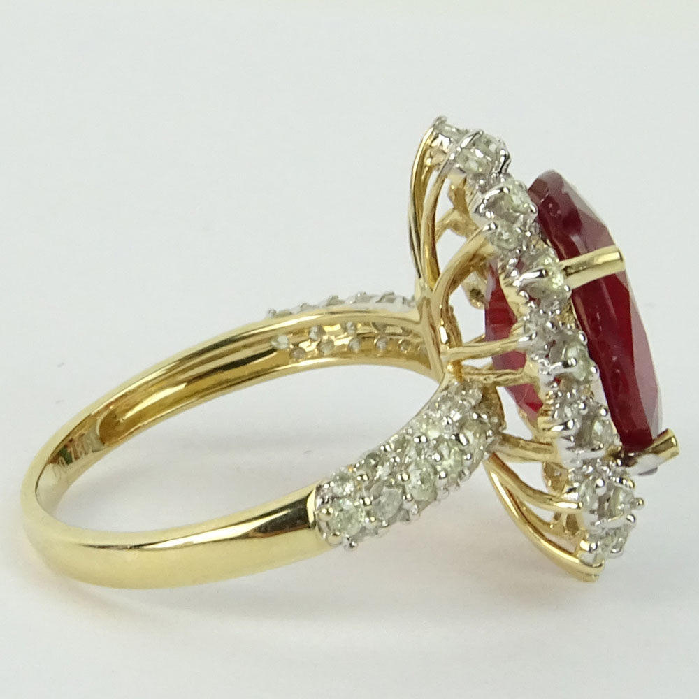 GGA Certified 7.12 Carat Oval Cut Ruby, .78 Carat Round Cut Diamond and 14 Karat Yellow Gold Ring. 