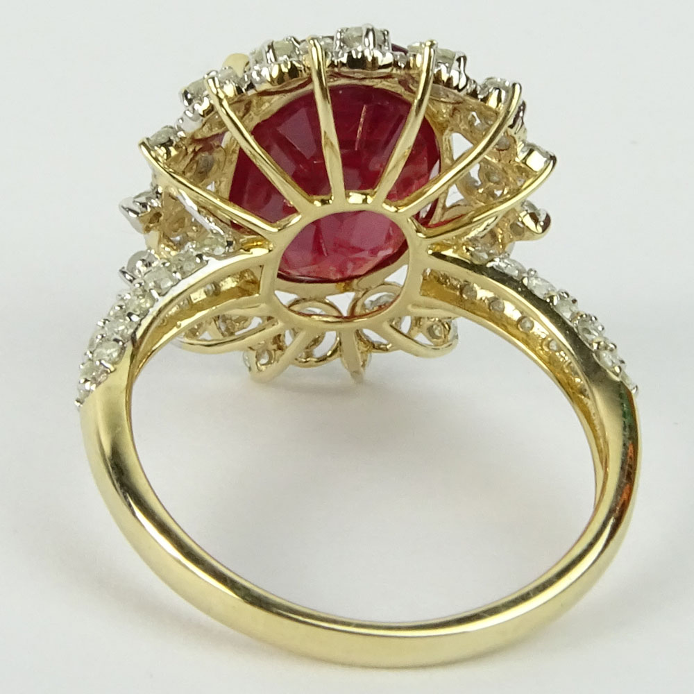 GGA Certified 7.12 Carat Oval Cut Ruby, .78 Carat Round Cut Diamond and 14 Karat Yellow Gold Ring. 