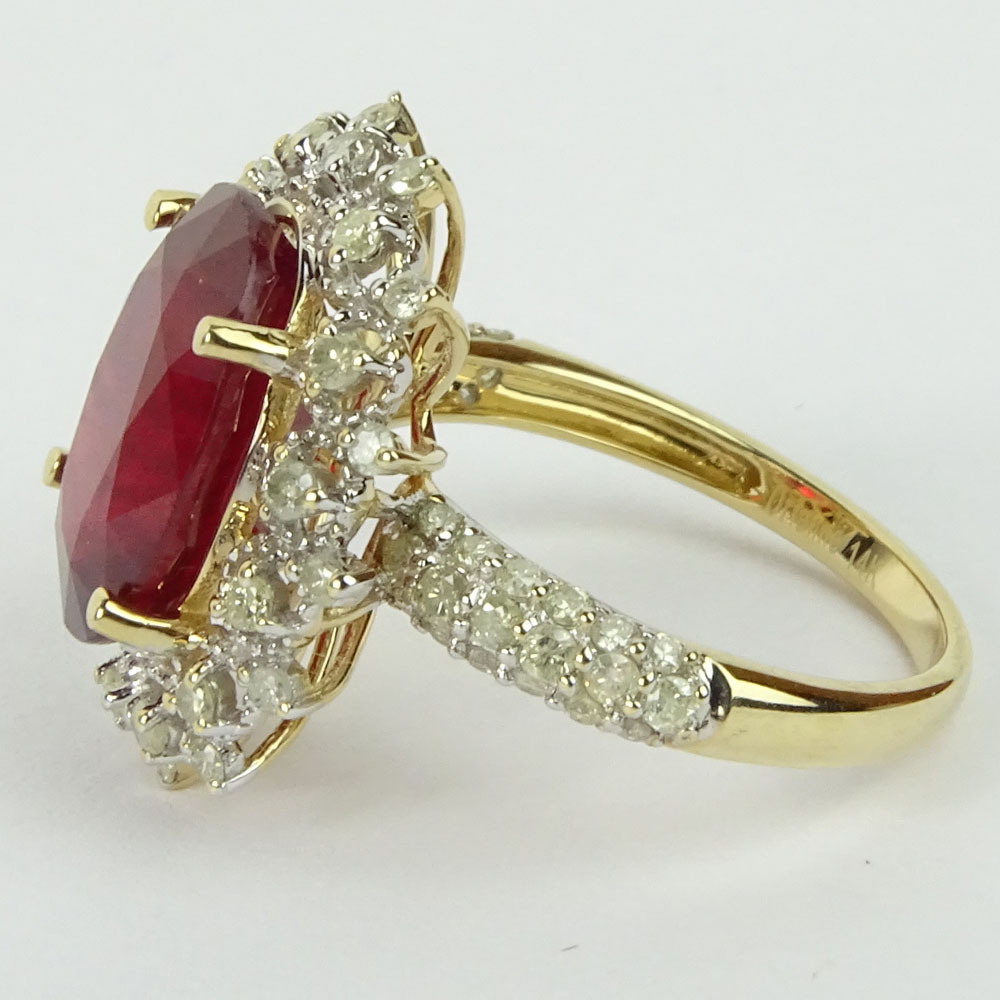 GGA Certified 7.12 Carat Oval Cut Ruby, .78 Carat Round Cut Diamond and 14 Karat Yellow Gold Ring. 