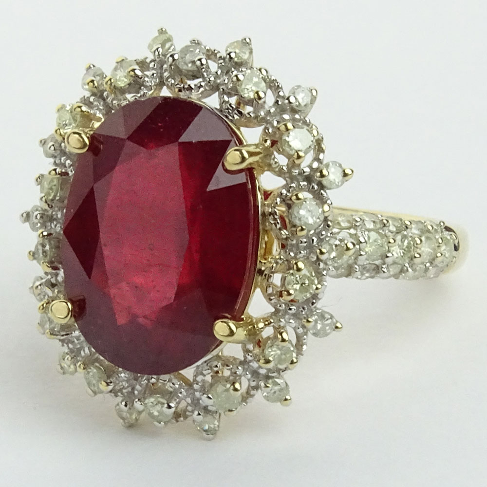 GGA Certified 7.12 Carat Oval Cut Ruby, .78 Carat Round Cut Diamond and 14 Karat Yellow Gold Ring. 