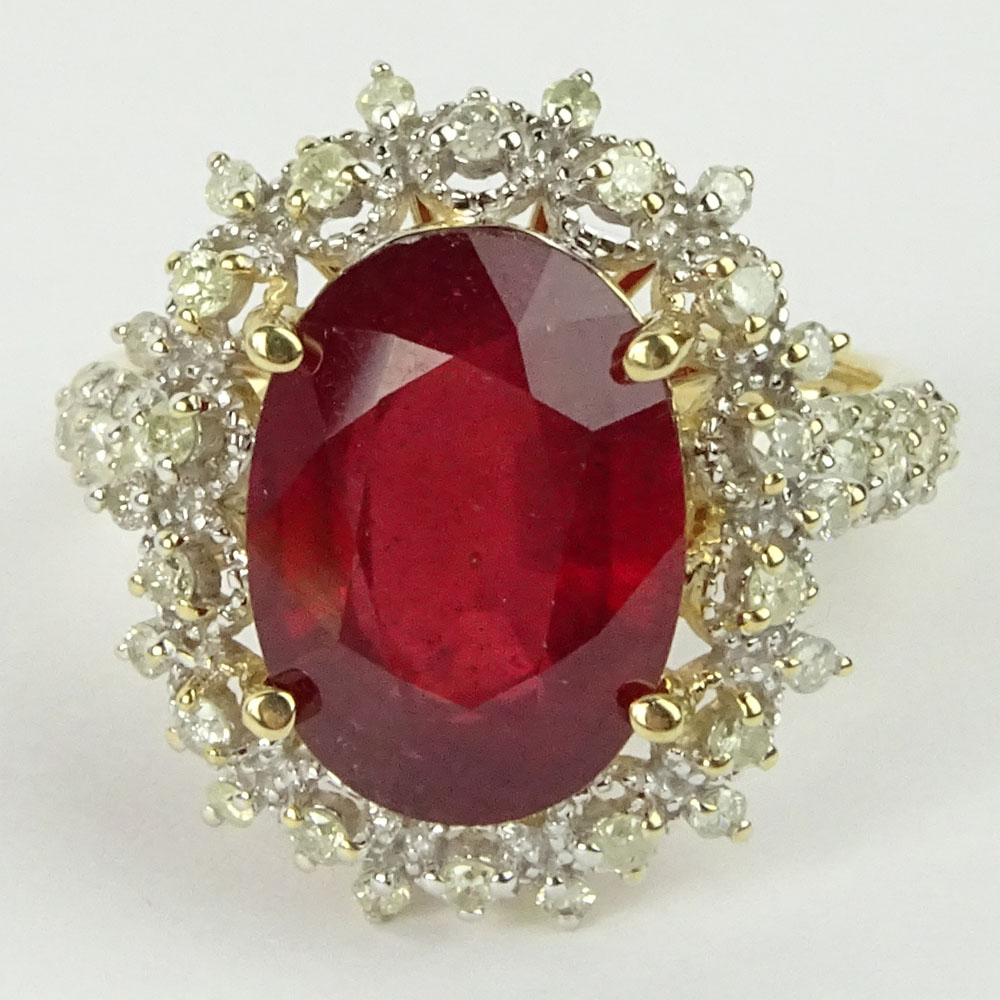 GGA Certified 7.12 Carat Oval Cut Ruby, .78 Carat Round Cut Diamond and 14 Karat Yellow Gold Ring. 