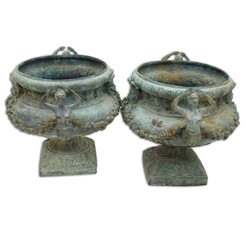Pair of bronze jardinières with mermaid handles and figural motif.