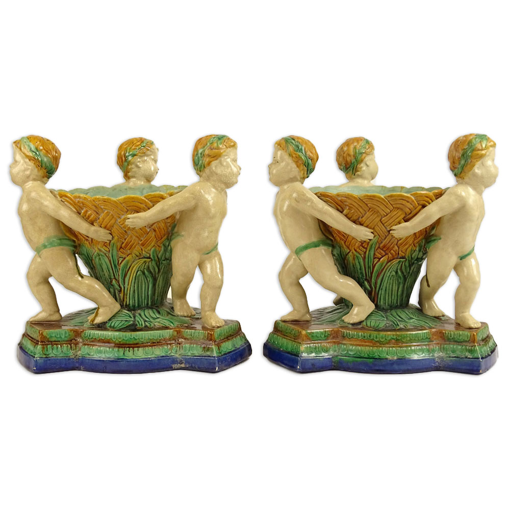 Pair Modern Figural Minton Style Majolica Planters. Each depicts three cherubs.