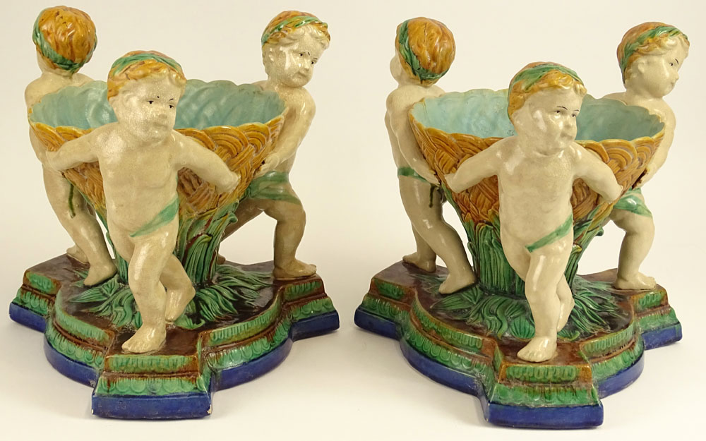 Pair Modern Figural Minton Style Majolica Planters. Each depicts three cherubs.