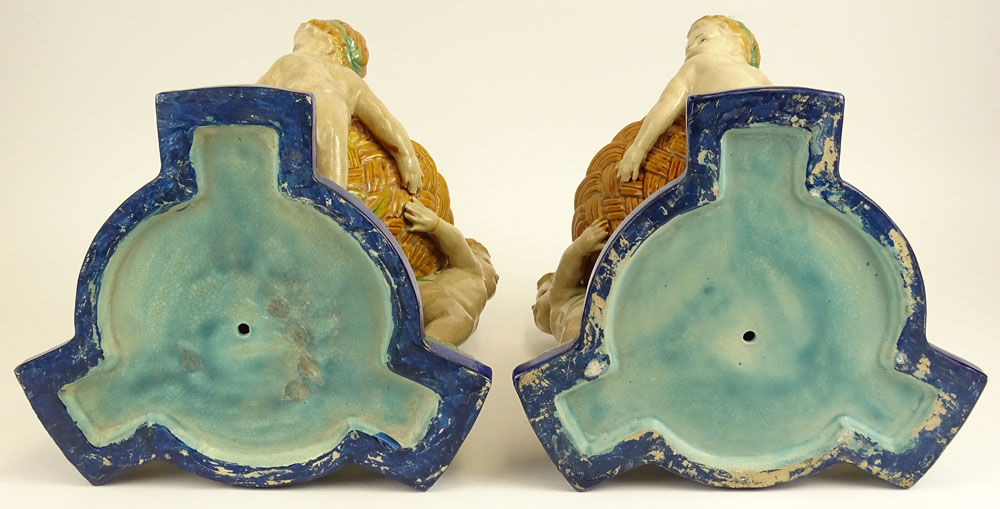 Pair Modern Figural Minton Style Majolica Planters. Each depicts three cherubs.