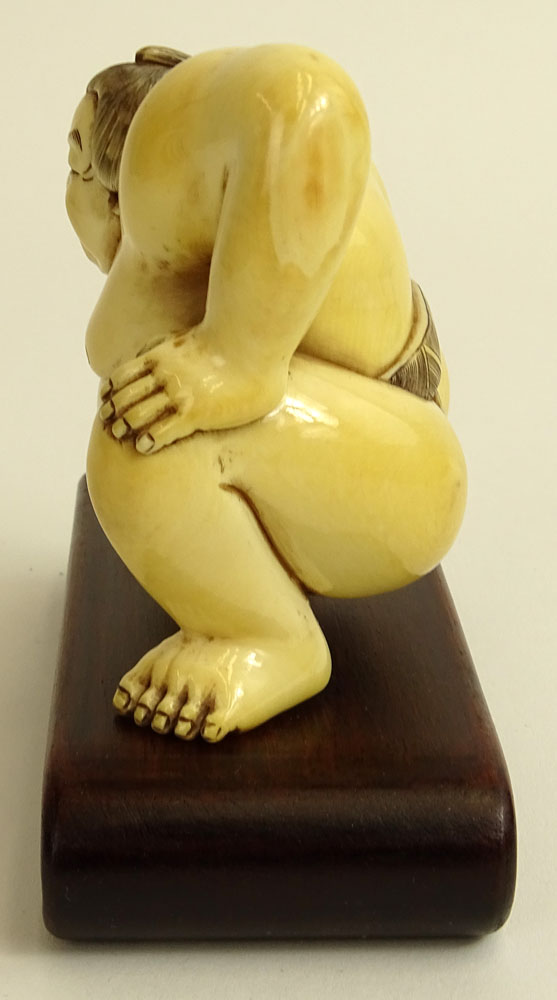 Vintage Japanese Carved Ivory Figure of a Sumo Wrestler on hardwood stand.