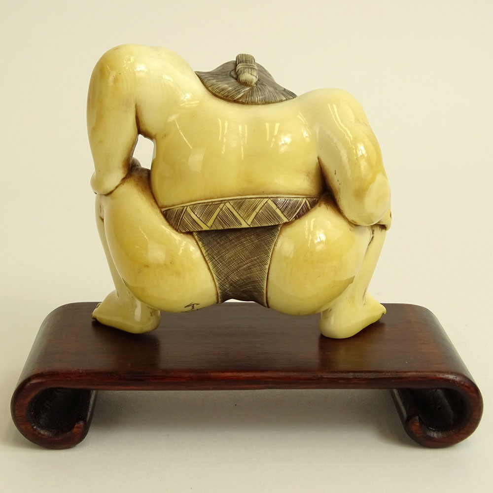 Vintage Japanese Carved Ivory Figure of a Sumo Wrestler on hardwood stand.