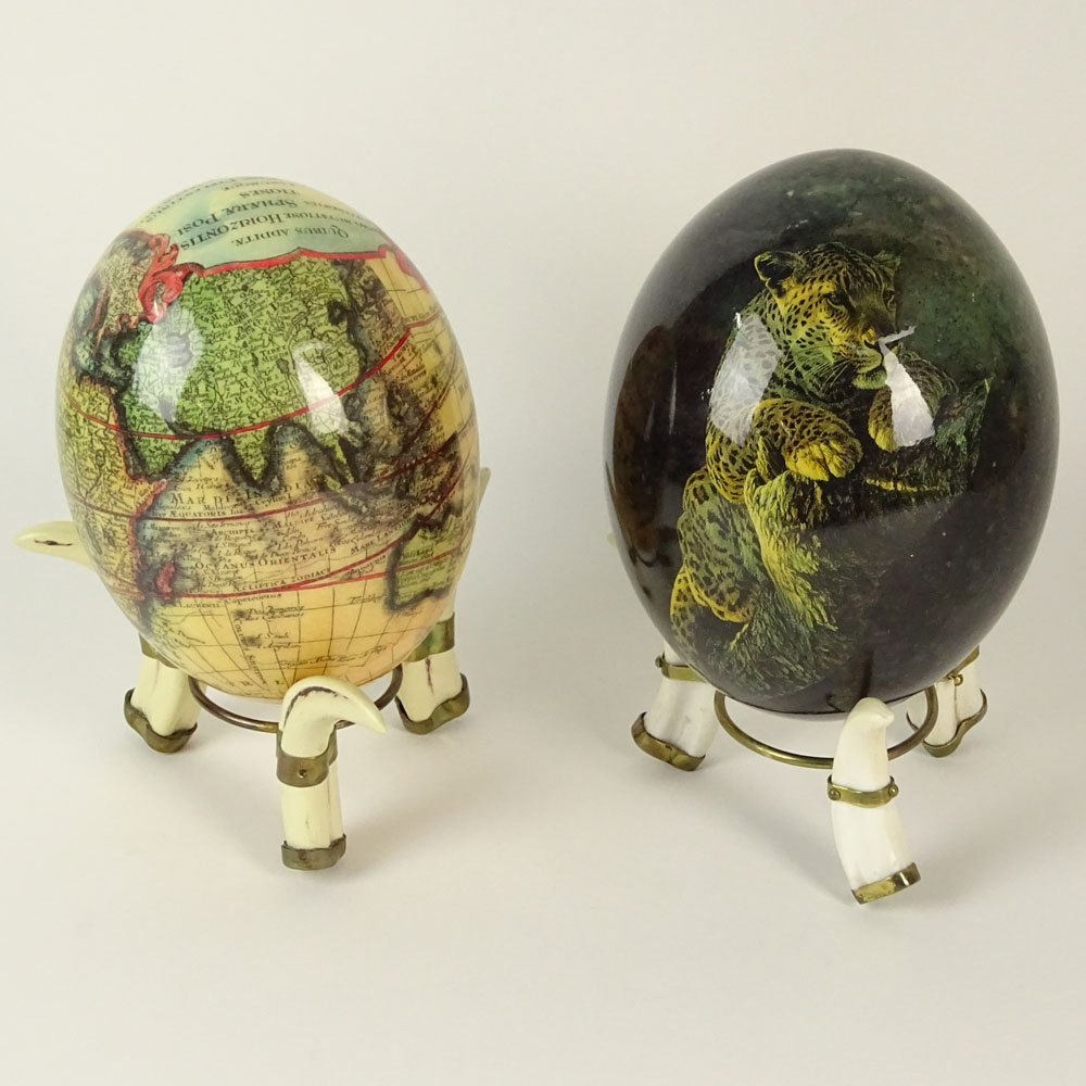 Pair of South African Decoupage Ostrich Eggs on Boar Tusk Stands.