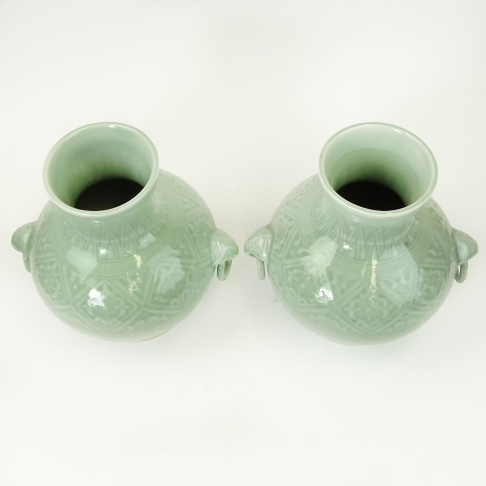 Pair of 2 Contemporary Korean Style Porcelain Figural Ring Handled Vases.