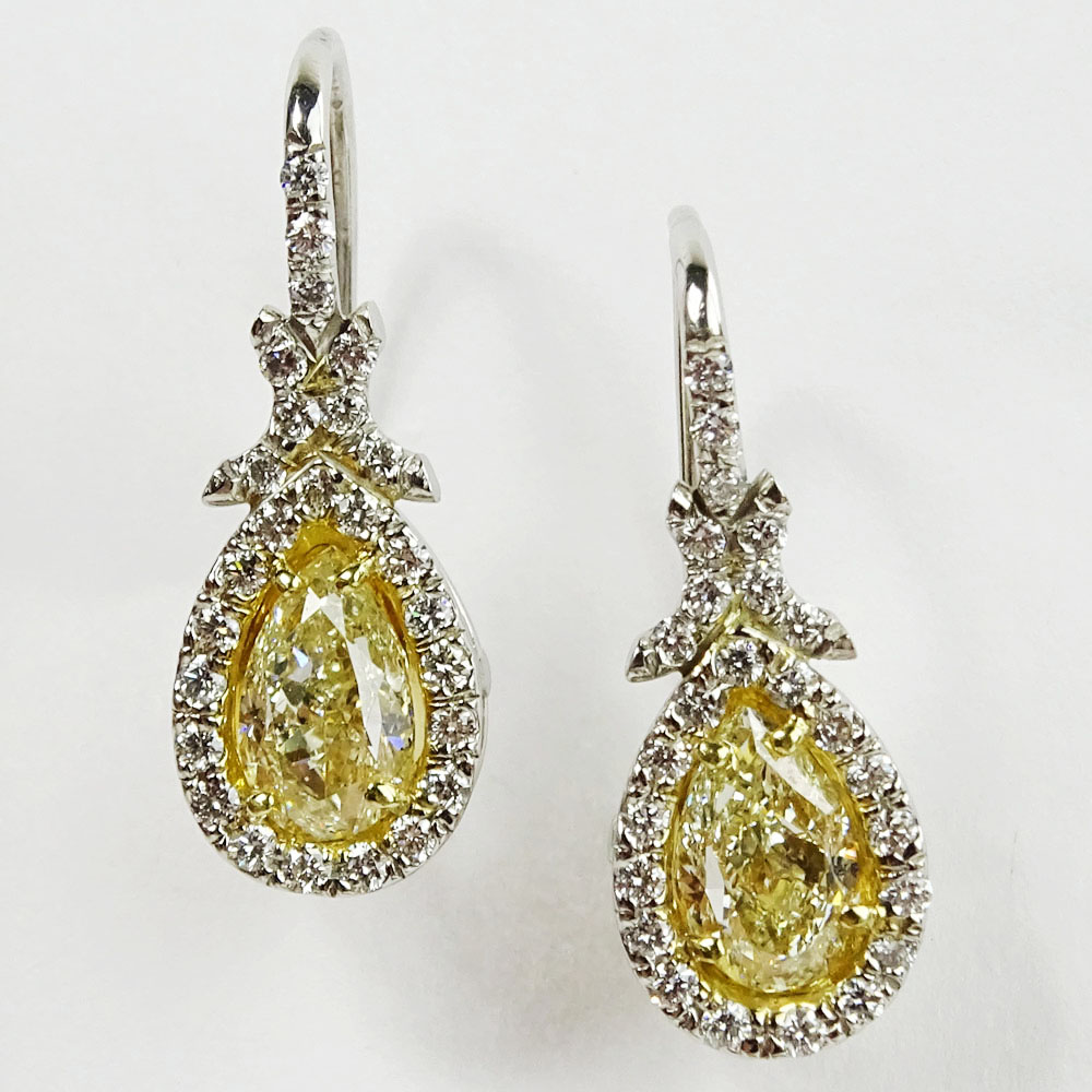 EGL Certified 2.02 Carat Pear Brilliant Cut Fancy Yellow Diamond and Platinum Earrings.