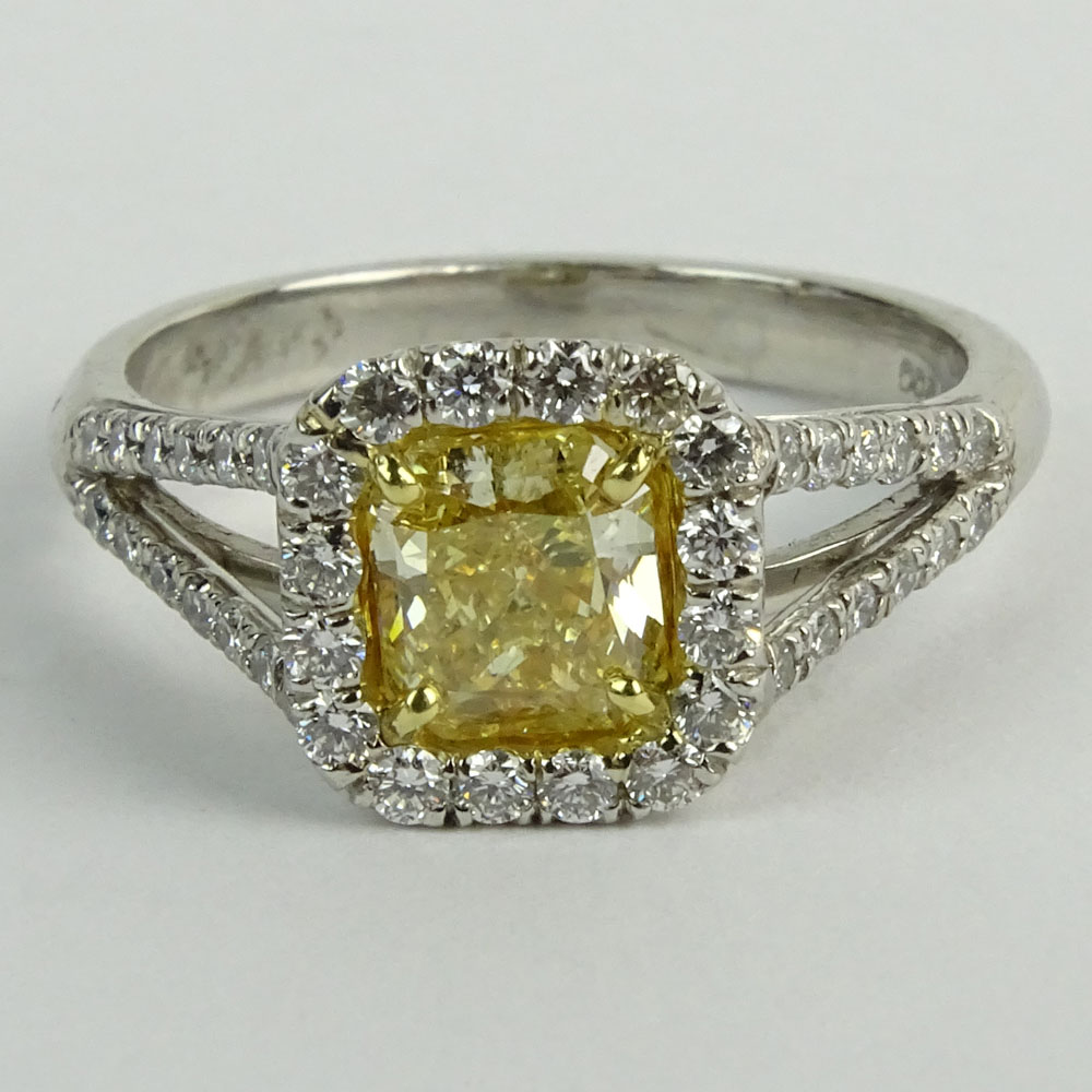 1.01 Radiant Cut Fancy Yellow Diamond, Platinum and 18 Karat yellow Gold Engagement Ring.