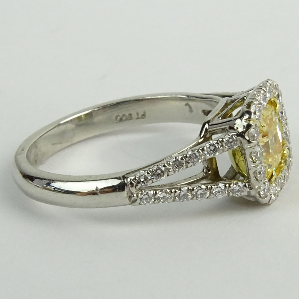 1.01 Radiant Cut Fancy Yellow Diamond, Platinum and 18 Karat yellow Gold Engagement Ring.