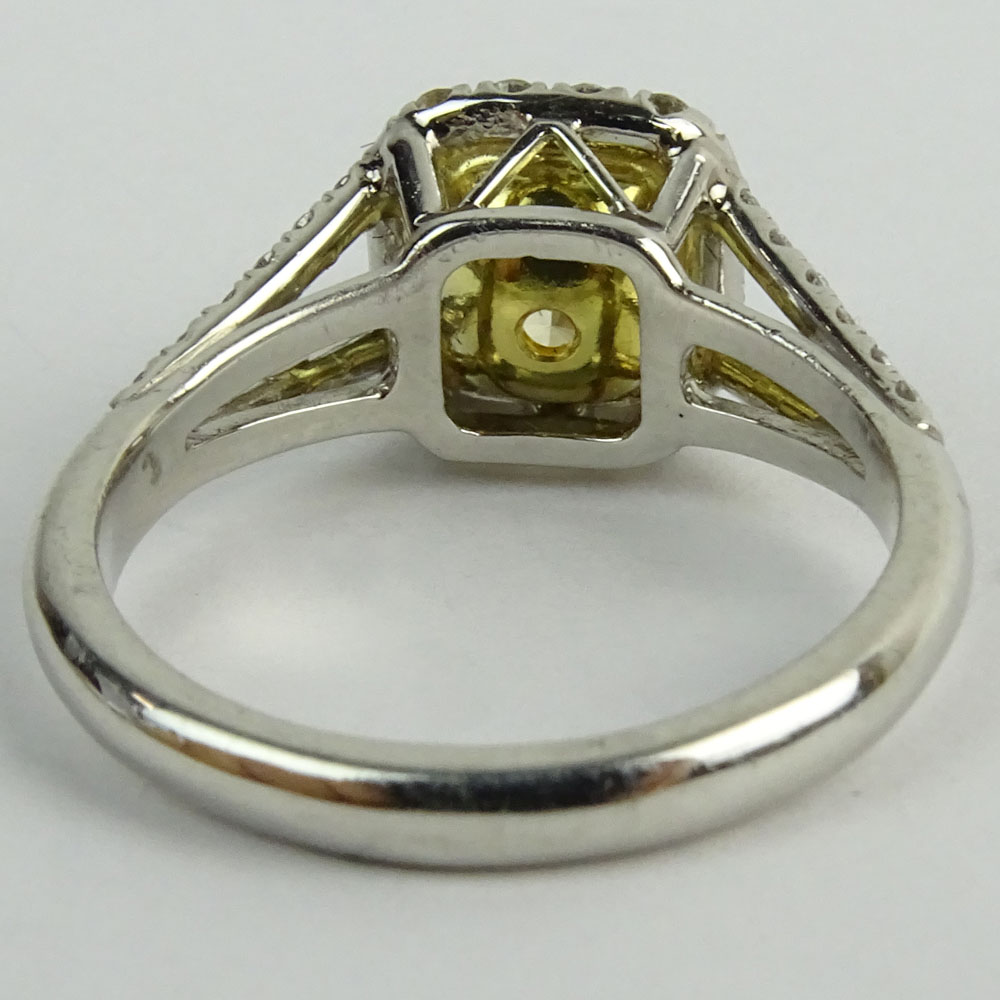 1.01 Radiant Cut Fancy Yellow Diamond, Platinum and 18 Karat yellow Gold Engagement Ring.