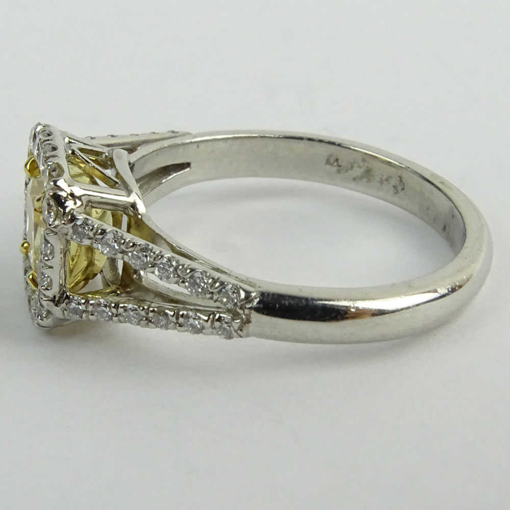 1.01 Radiant Cut Fancy Yellow Diamond, Platinum and 18 Karat yellow Gold Engagement Ring.