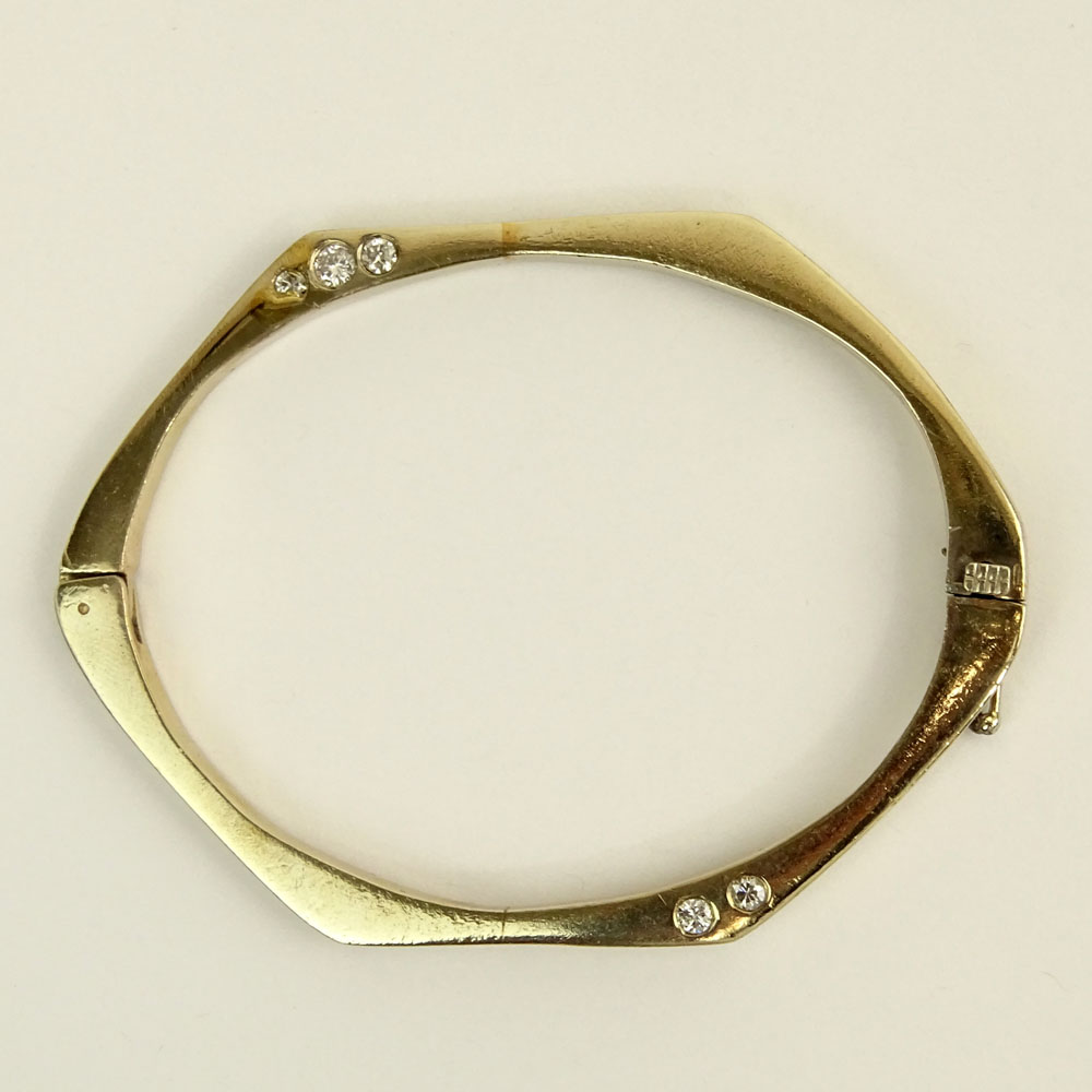 Vintage 14 Karat Yellow Gold Bangle Bracelet accented with Ten (10) Round Cut Diamonds.