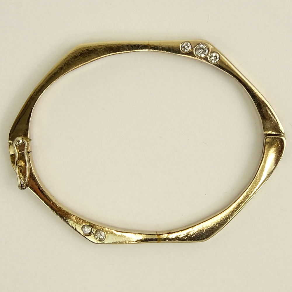 Vintage 14 Karat Yellow Gold Bangle Bracelet accented with Ten (10) Round Cut Diamonds.