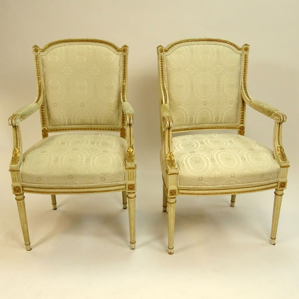 Pair of Mid 20th Century Italian Louis XVI style Carved Painted and Parcel Gilt Arm Chairs.